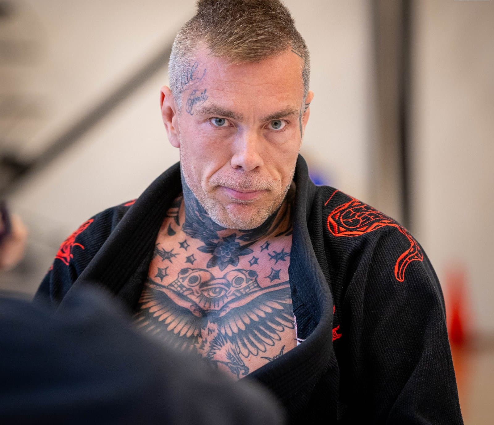 Miko Hytönen's chest tattoo beside the matching red embroidery on his kimono