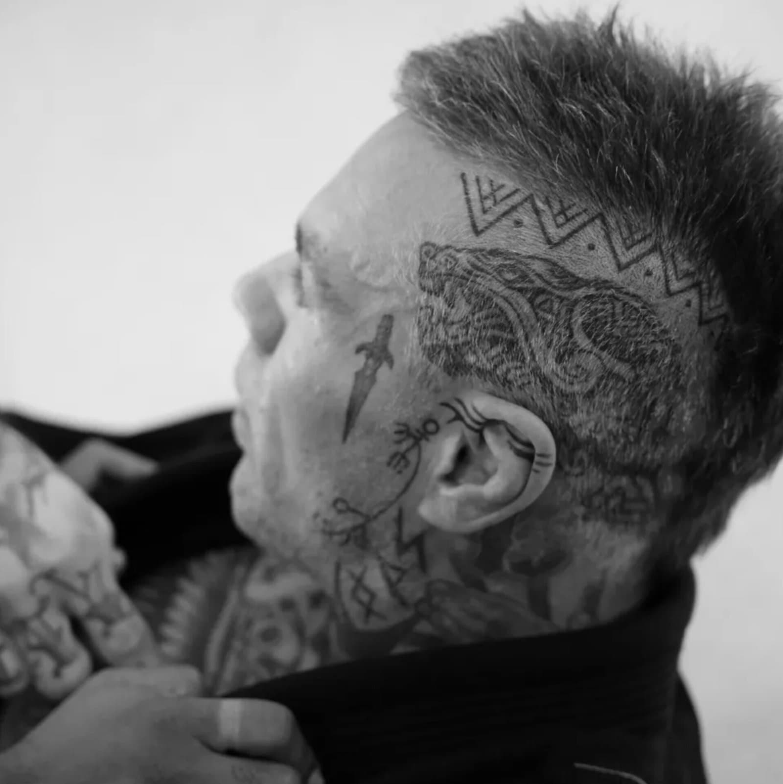 Close-up of Miko Hytönen's Nordic head and neck tattoos